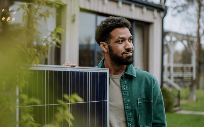 Homme à coté d'un panneau solaire